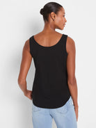 Black tank top on a model from behind, featuring a scooped back neckline and a rounded shirt-tail hem.