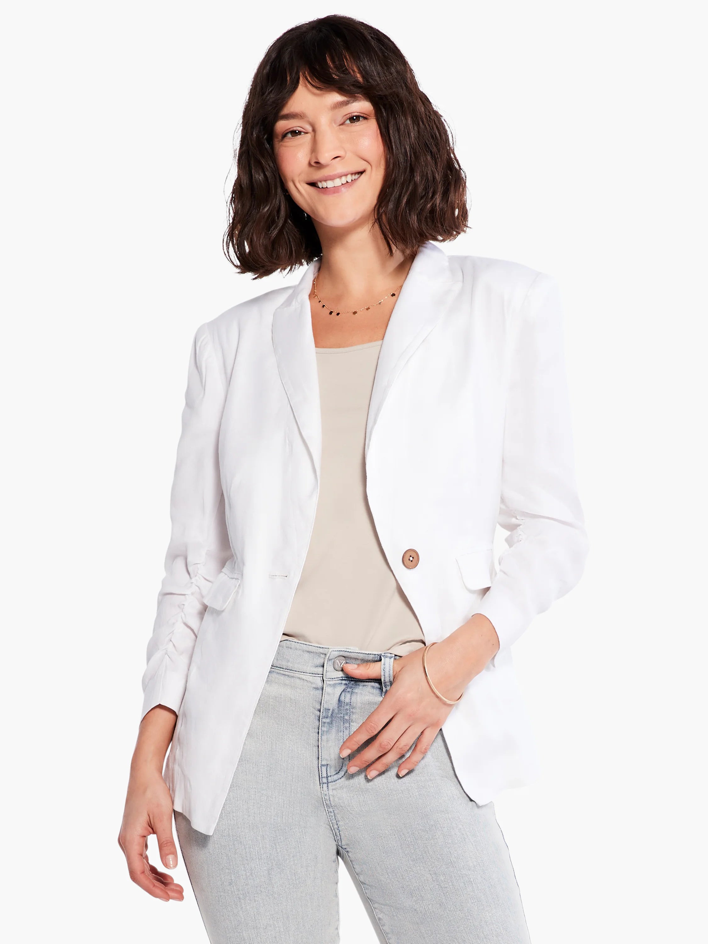 Light beige tank top with a rounded neck, partially visible under a white blazer.