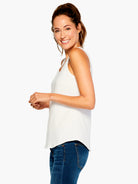 Off-white scoop neck tank top with a curved, shirt-tail hem.