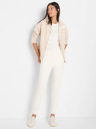 White ribbed knit short sleeve crew neck tee, worn under an open jacket.