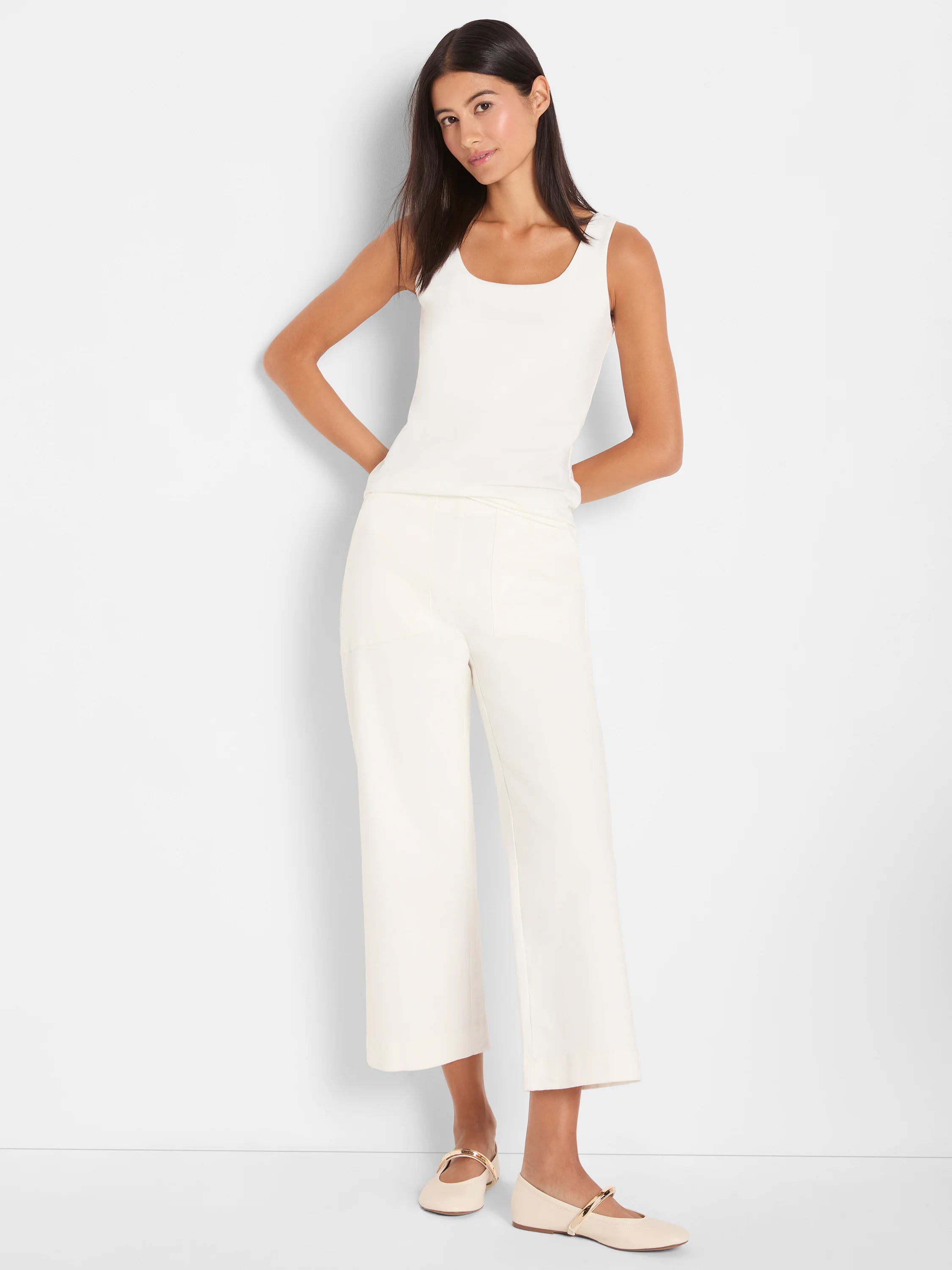 Ivory square-neck tank top, sleeveless and form-fitting.