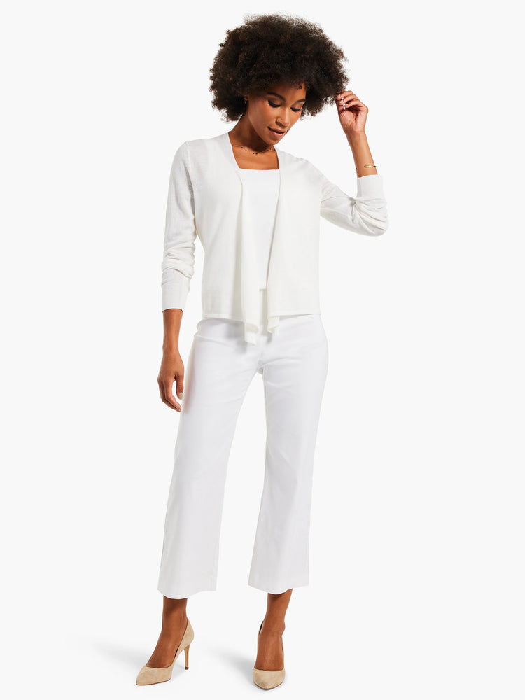 White sleeveless tank top with a straight neckline, visible under an open white cardigan.