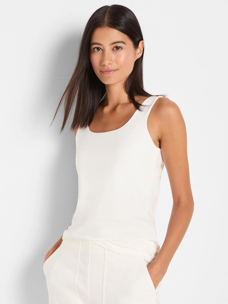 White scoop neck shelf bra tank top on a woman.