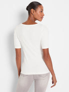 Off-white, fitted, ribbed knit tee with elbow sleeves. Features a wide, shallow scoop back neckline.