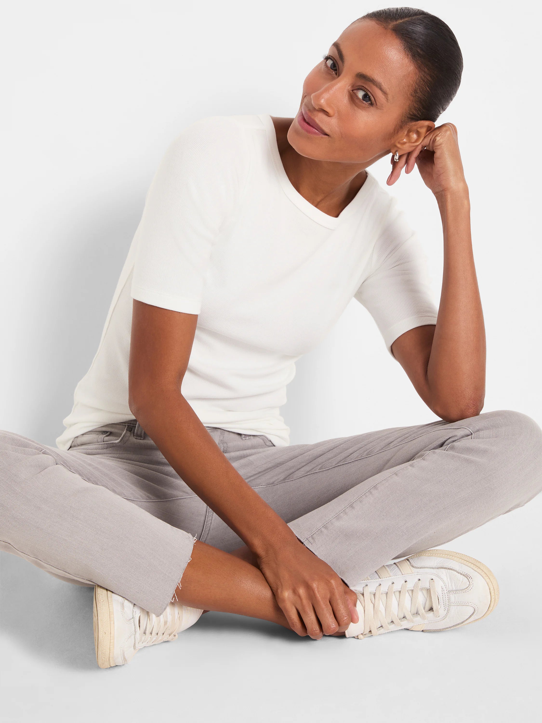 Off-white ribbed knit boatneck tee with elbow-length sleeves, worn by a model.