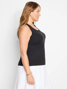 Black ribbed knit tank top with a scoop neck. Features vertical ribbing.