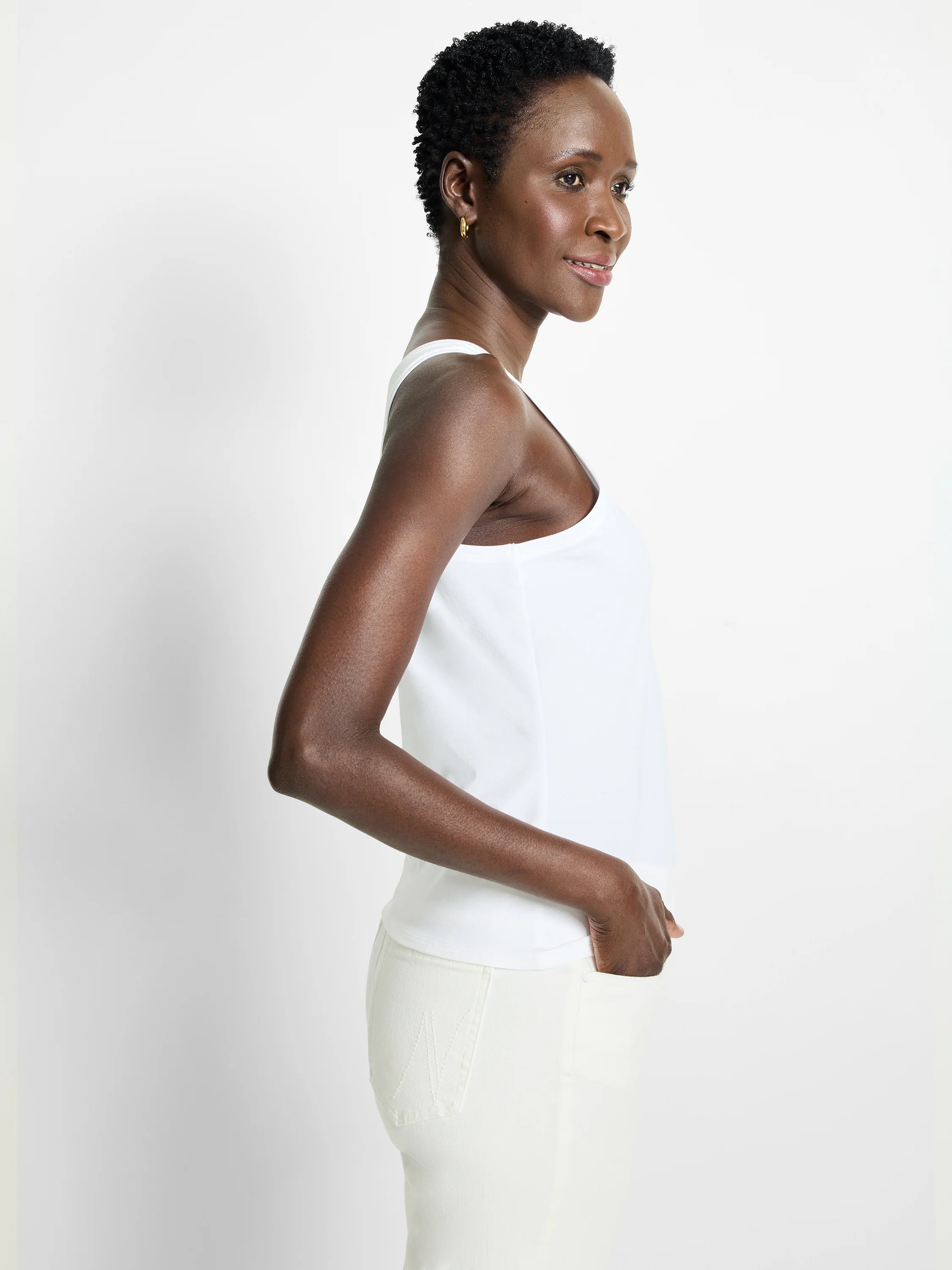 White high-neck tank top, smooth fabric, modeled from the side.