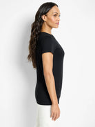 Black crew neck t-shirt with short sleeves and smooth knit, worn by a model shown in profile.
