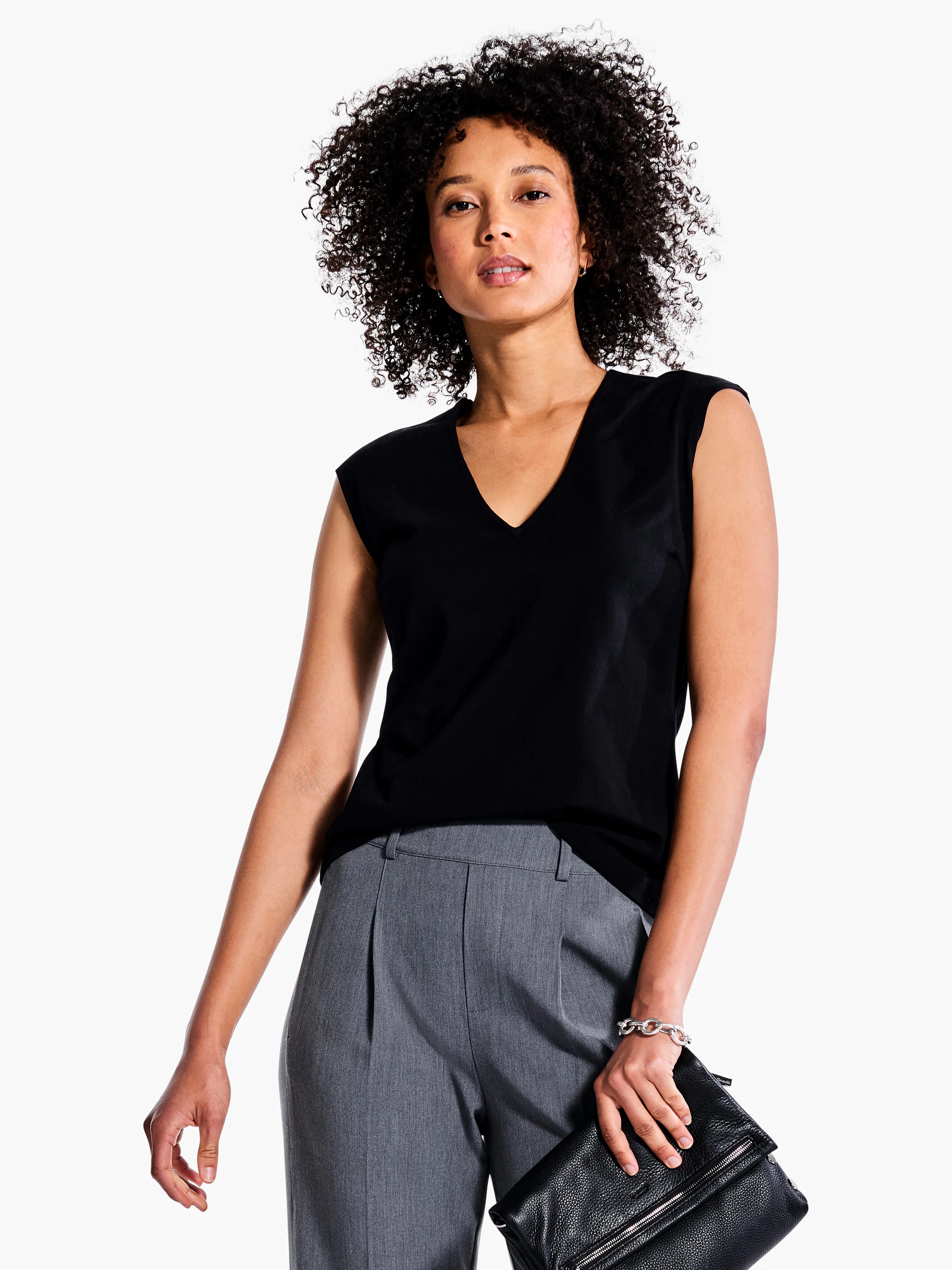 Black v-neck sleeveless top.  Model is wearing gray pants.