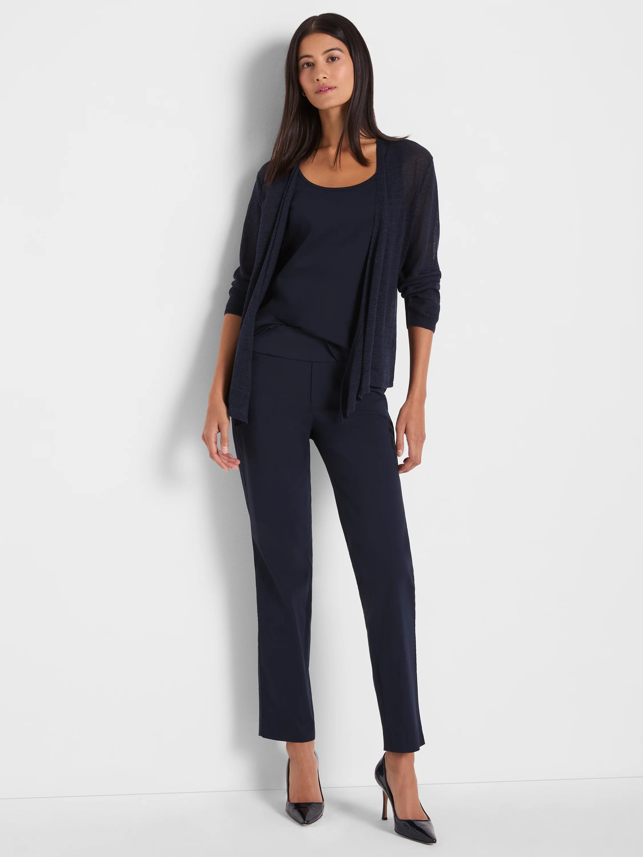 Navy blue open-front cardigan with sheer, lightweight knit and ribbed cuffs, shown draped on a woman.