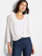 Off-white, lightweight, semi-sheer cardigan with long sleeves and ribbed cuffs, tied in a knot at the waist.
