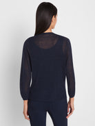 Lightweight sheer navy knit sweater features long sleeves and a cropped, relaxed fit above matching pants.