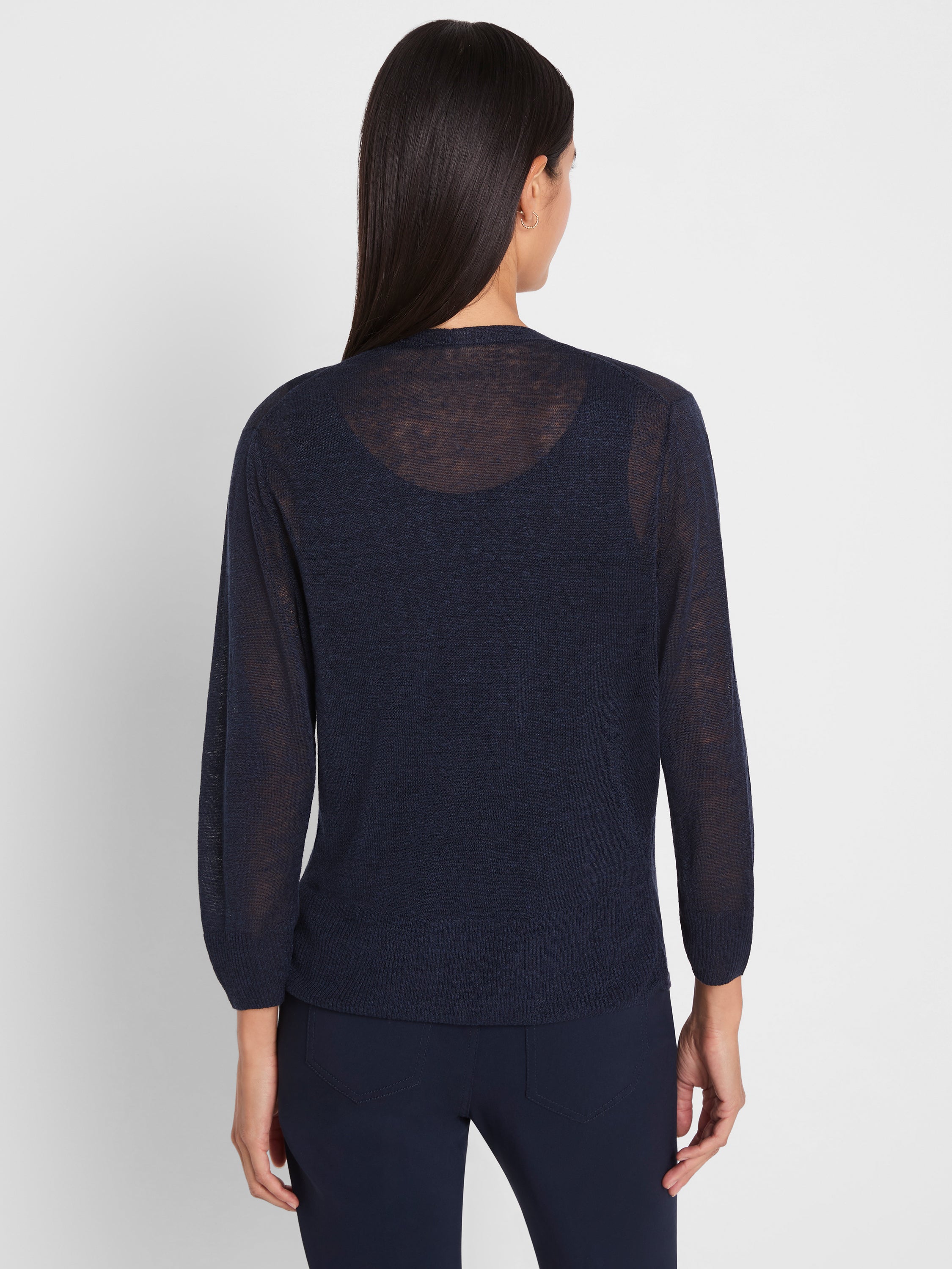 Lightweight sheer navy knit sweater features long sleeves and a cropped, relaxed fit above matching pants.