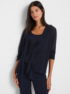 The model wears a sheer navy knit cardigan with three-quarter sleeves and a relaxed, draped open front.