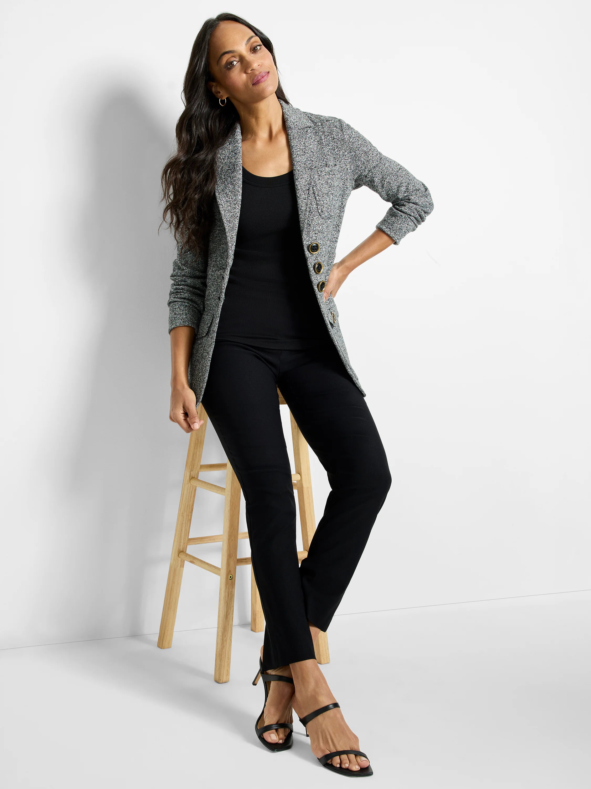 Editor Knit Blazer in speckled black and white knit, with notch lapels and three gold-rimmed buttons.