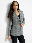 Speckled grey knit blazer with notched lapels, three front buttons, and two patch pockets, all with gold-rimmed buttons.
