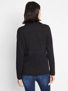 Black knit blazer, back view. Collared, with horizontal seams across upper back and waist.