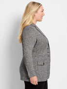 Grey marl knit blazer with lapels, three buttons, and a flap pocket featuring a brass button.