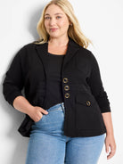 Black knit blazer with notched lapels, four flap pockets, and three gold-rimmed black buttons.