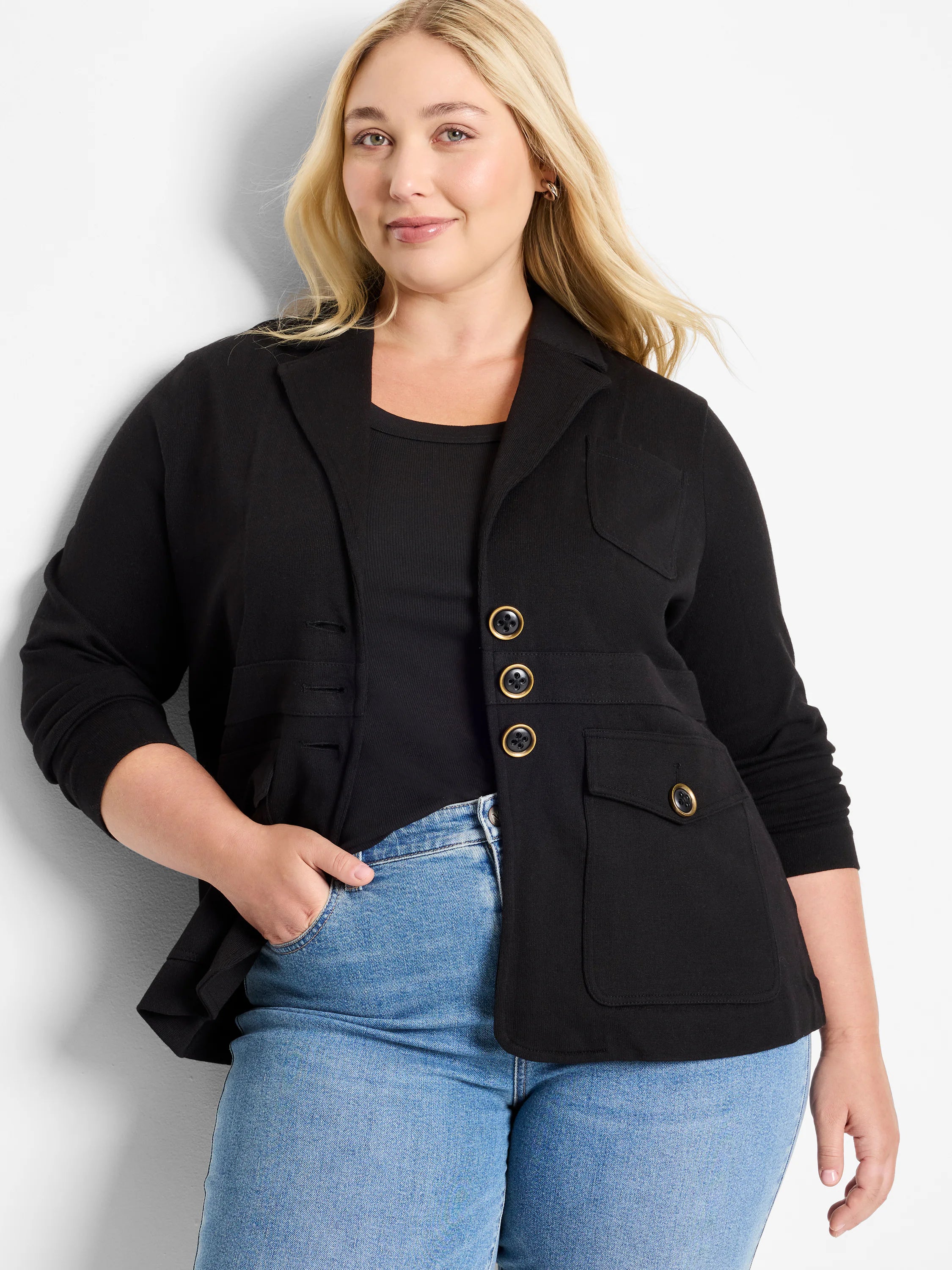 Black knit blazer with notched lapels, four flap pockets, and three gold-rimmed black buttons.
