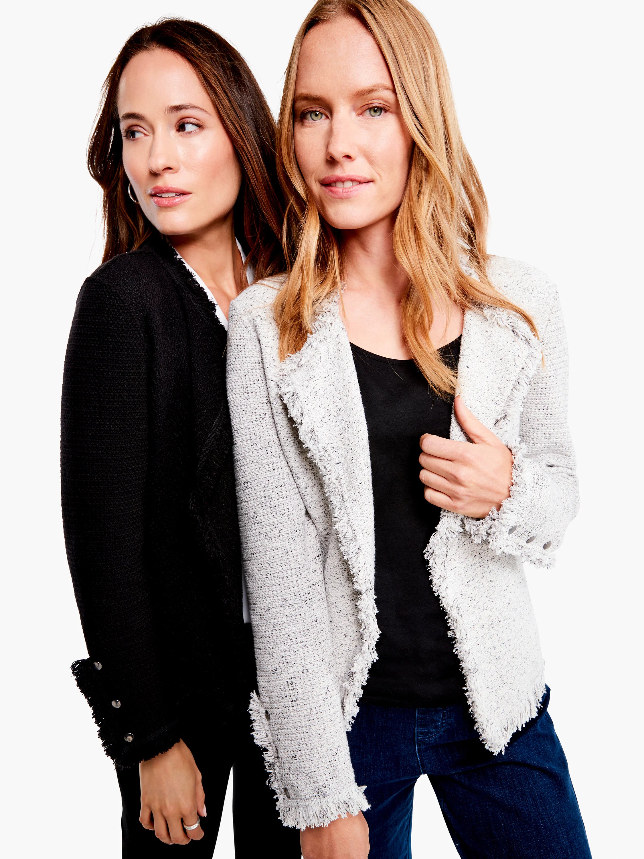 Two knit jackets: black and speckled light grey. Both feature fringe trim on the front opening and cuffs.