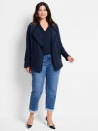 Dark blue textured knit jacket with fringe trim on lapel, front edges, and cuffs.