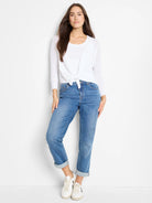 White long-sleeve cardigan tied in a knot at the front.