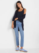 Navy blue, open-front, long-sleeve cardigan, worn by model. Falls to upper thigh.