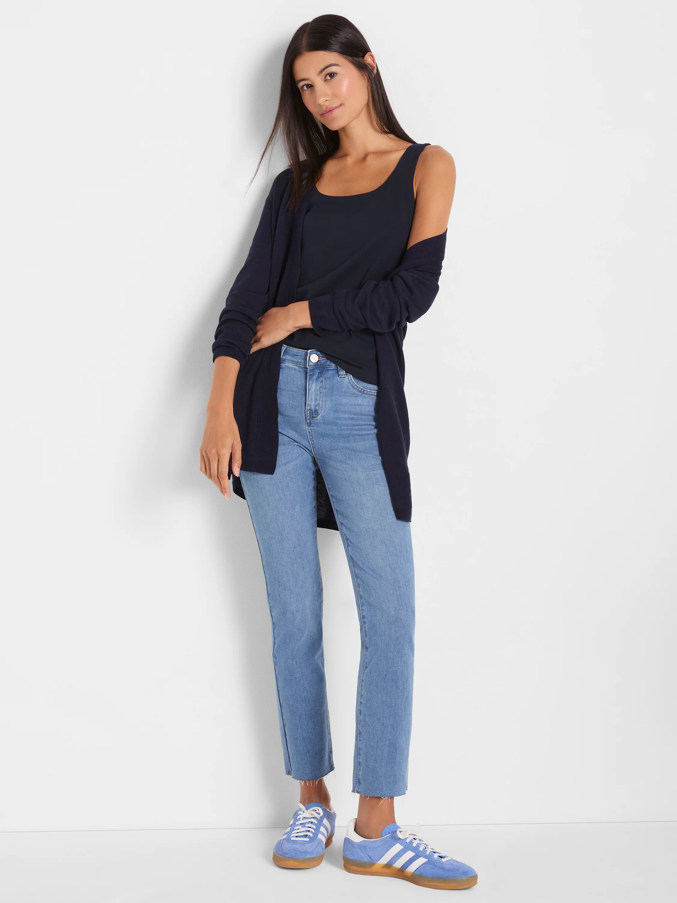 Navy blue, open-front, long-sleeve cardigan, worn by model. Falls to upper thigh.