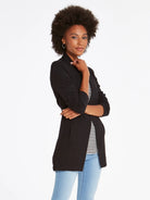 Black open knit jacket with long sleeves and a slightly longer back hem.
