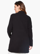 The model wears a sophisticated black longline knit blazer featuring a mock neck and a sleek, relaxed fit.