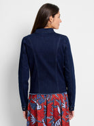 The model wears a dark wash fitted denim jacket styled with back princess seams and a raw frayed hem.