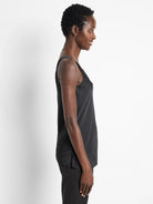 Black cami tank with black lace detail at neckline.  Side profile view.