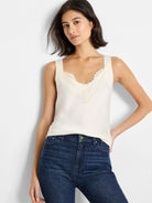 Off-white cami tank with off-white lace V-neckline.