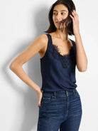 Navy blue cami tank with dark lace V-neck trim.