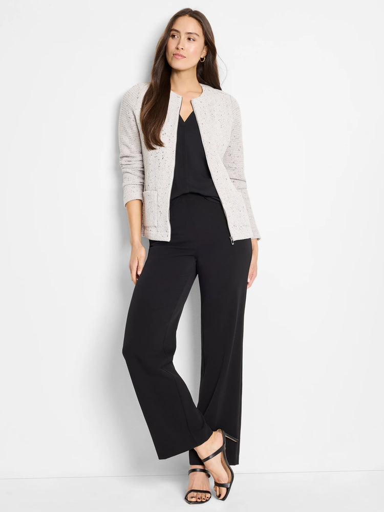 Light grey textured jacket with round collarless neckline, front zipper, and patch pockets, over black top and pants.