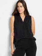 Black sleeveless top with a deep, draped V-neck and a relaxed fit.