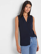 Navy blue sleeveless V-neck top with crossover front and asymmetrical hem.