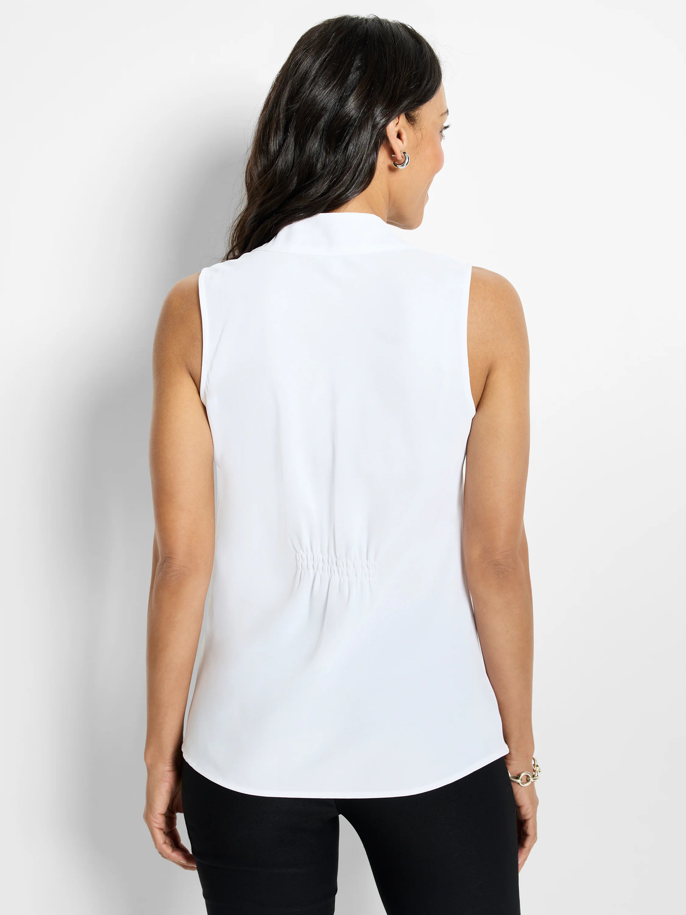 White sleeveless top, back view. Features a stand collar, back shirring, and a rounded hem.