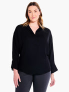 Black collared blouse, 3/4 sleeves with wide cuffs.  Model is wearing dark gray pants.