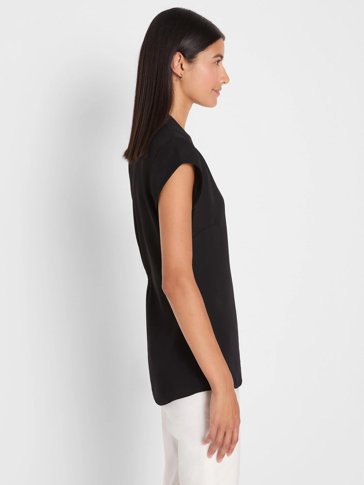 Black, collarless cap sleeve top with a relaxed fit, modeled in profile.