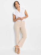 White cap sleeve top with a notched V-neckline.