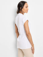 White cap-sleeve top with banded collar, back waist ruching, and tunic length.