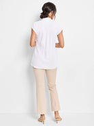 White cap sleeve top, back view. Stand collar, shirred elastic back waist detail.