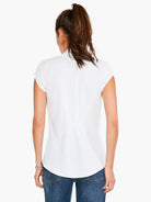 White cap-sleeve top, back view.  Elasticated waist.  Model wears blue jeans.