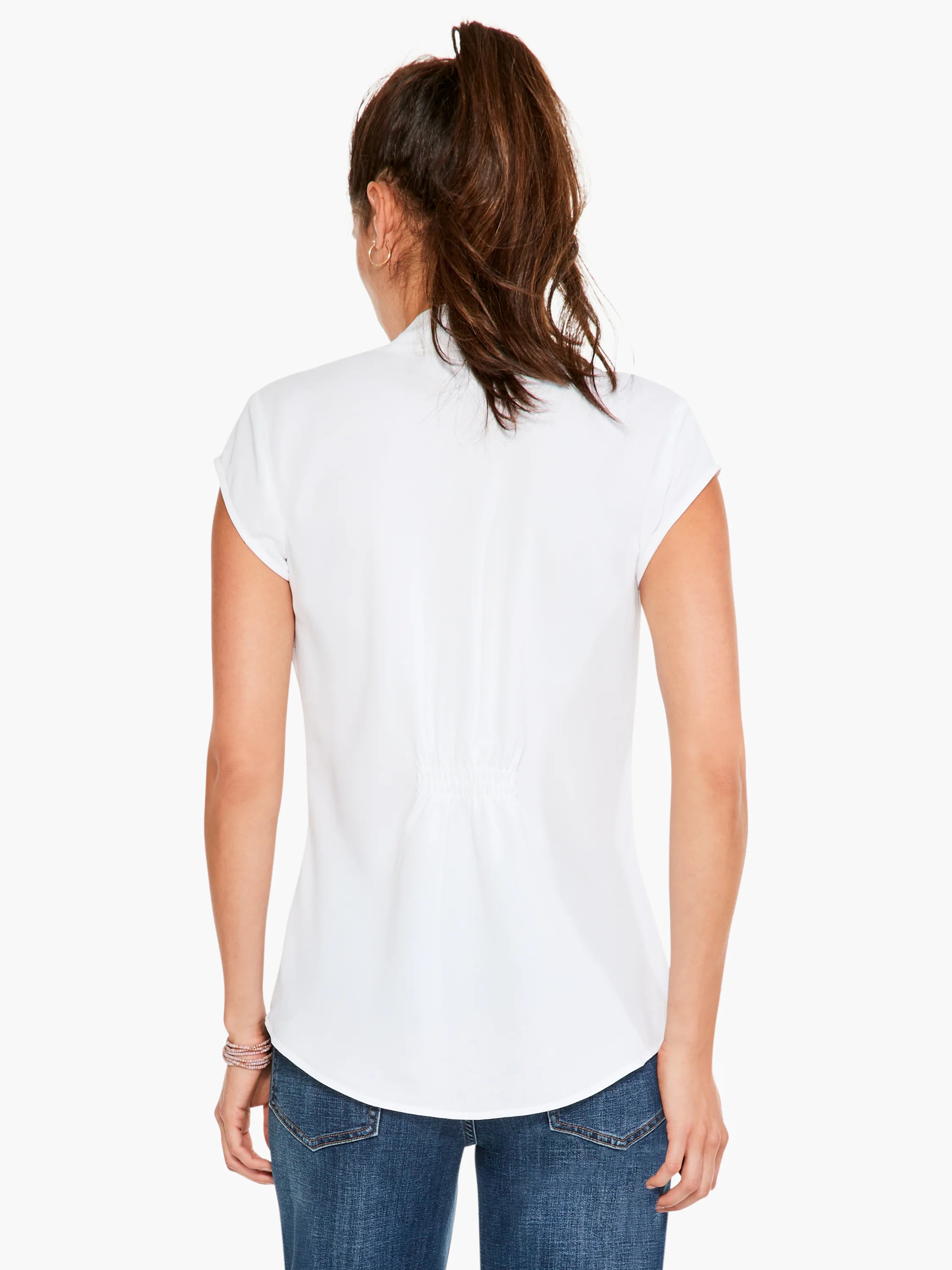 White cap-sleeve top, back view.  Elasticated waist.  Model wears blue jeans.
