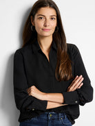 Black popover shirt with a classic collar, open neckline, and long sleeves with buttoned cuffs. Loose fit.