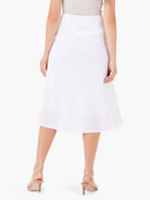 White linen slip skirt with a textured finish. Back view, midi length, subtle A-line silhouette.