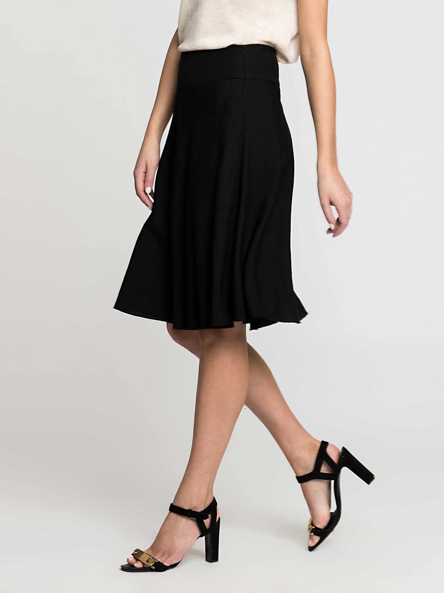 Black high-waisted flared skirt with a wide waistband, falling to just above the knee.