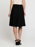 Black A-line skirt with smocked waistband, above-knee length, modeled from behind.